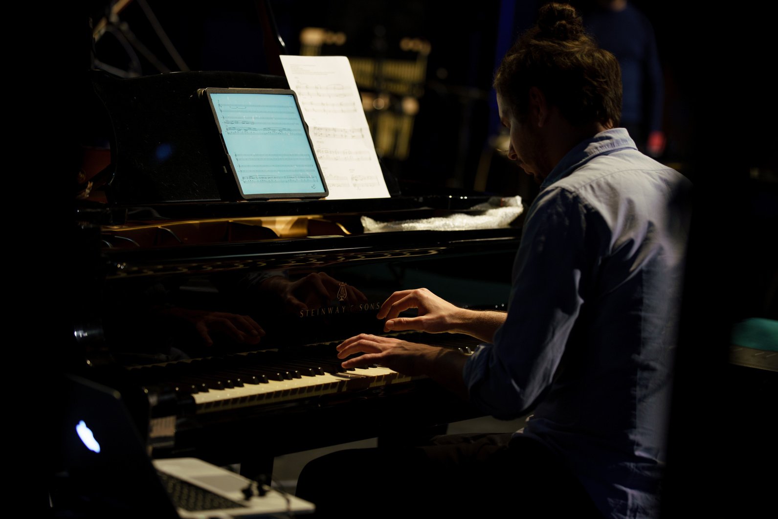 a person playing the piano in a dark room